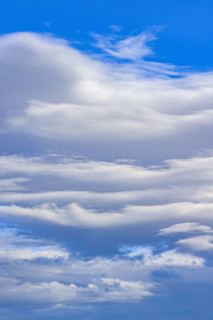 White lenticular clouds on blue sky