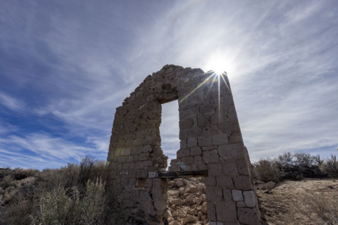 Sun shining through abandoned church in desert