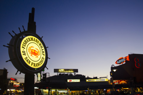 Illuminated signs at Fisherman's Wharf at twilight