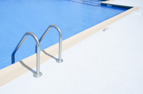 Edge of swimming pool on sunny day