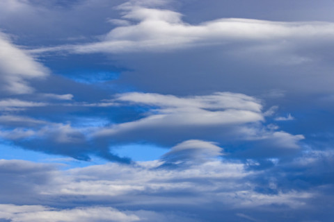 White lenticular clouds in afternoon
