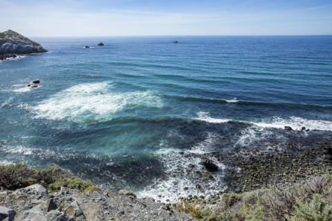 Calm ocean waves washing Big Sur coast