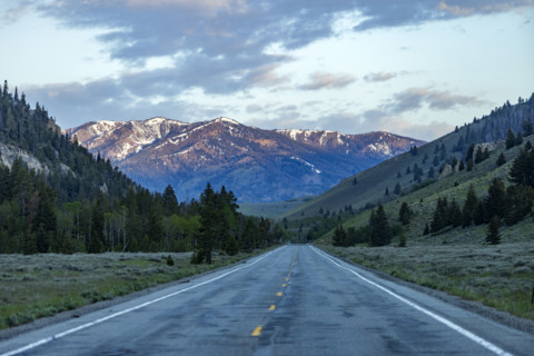 Empty highway 75 with mountains in distance at sunset
