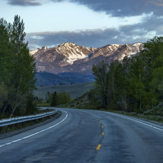 Empty highway 75 with mountains in distance at sunset