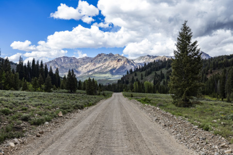 Empty dirt road leading to mountains