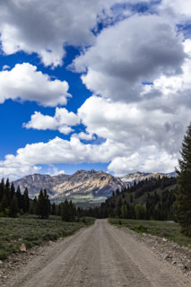 Empty dirt road leading to mountains