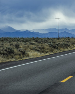 Dramatic sky above empty highway and mountains