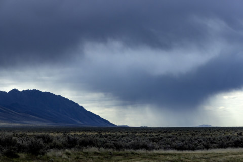 Storm clouds and rain above fields