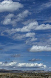 Clouds above grassy fields