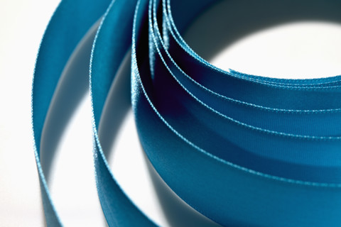 Close-up of blue ribbon on white background