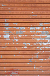 Close-up of old orange metal door