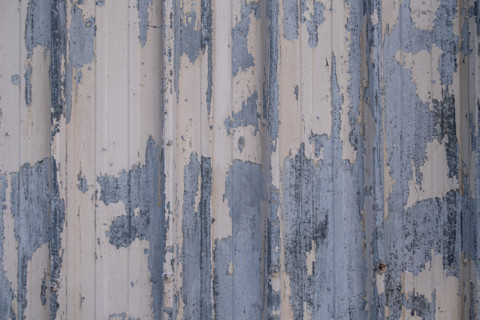 Close-up of metal wall with peeling paint