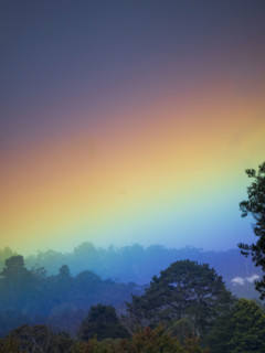 Rainbow colored sky above landscape