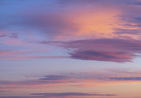 Pink and orange clouds against blue sky
