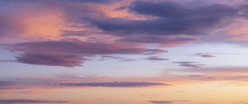 Pink and orange clouds against blue sky