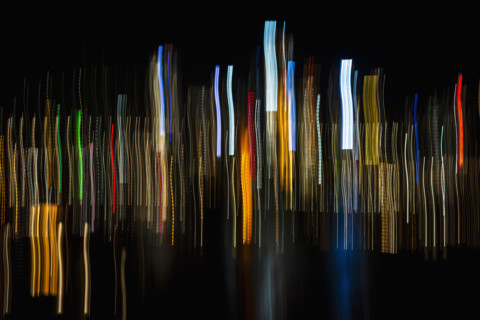 Vertical light trails on dark background