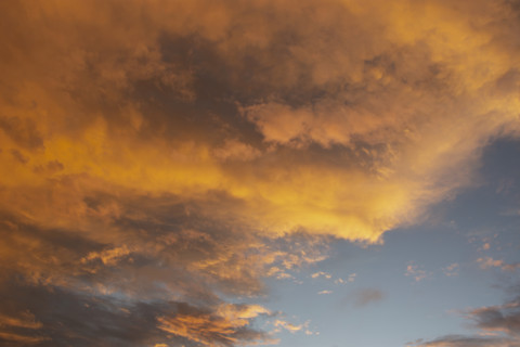 Storm clouds colored by setting sun
