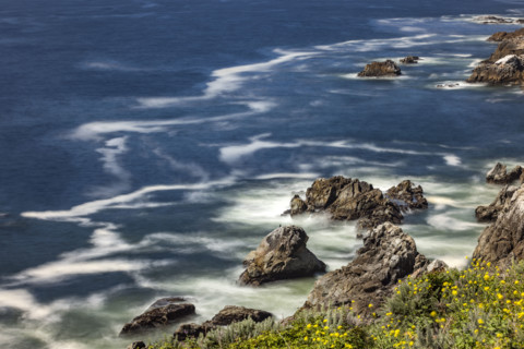 Water swirling around rocks, motion blur