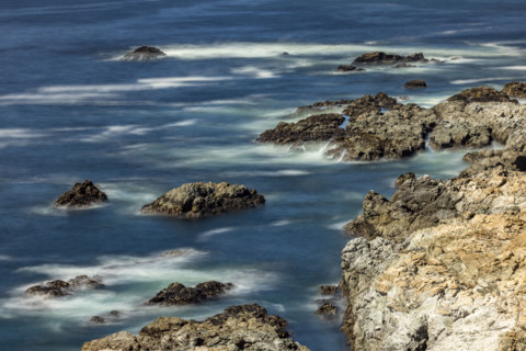 Water swirling around rocks, motion blur