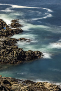 Water swirling around rocks, motion blur