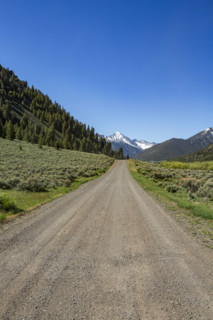 Empty dirt road to distant mountain