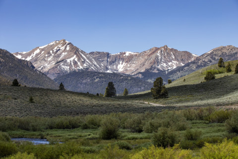 Green valley and mountains with snow