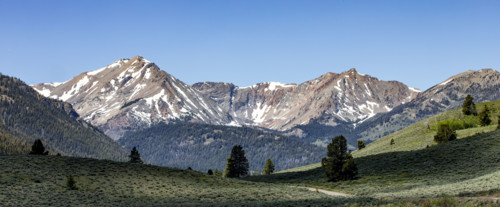 Green valley and mountains with snow
