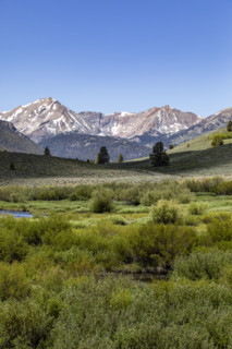 Green valley and mountains with snow
