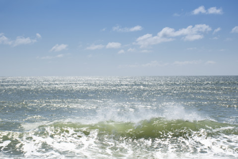 Crest of breaking wave on sunny day
