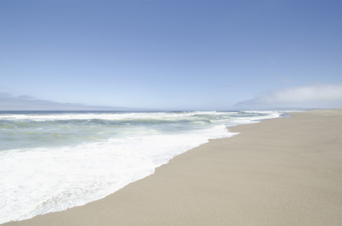 Ocean surf on calm empty beach