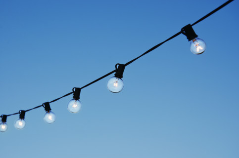 String of party lights against clear sky at twilight