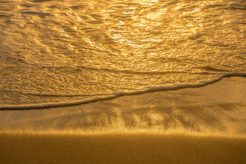 Sea wave washing sand at sunrise. Boca Raton, Florida, United States