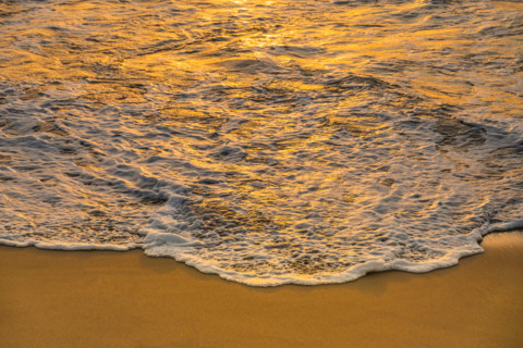 Sea wave washing sand at sunrise. Boca Raton, Florida, United States