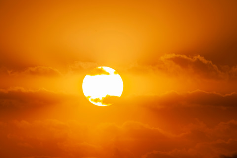 Sunrise passing though orange clouds. Boca Raton, Florida, United States