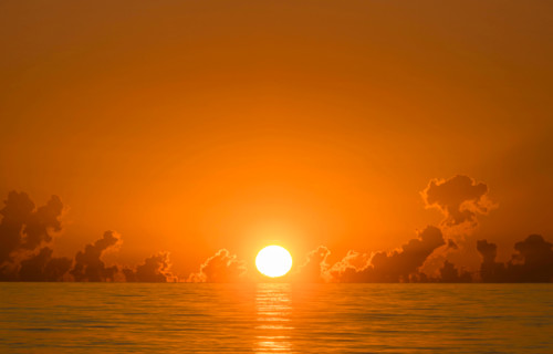 Orange sun coming up over Atlantic Ocean. Boca Raton, Florida, United States