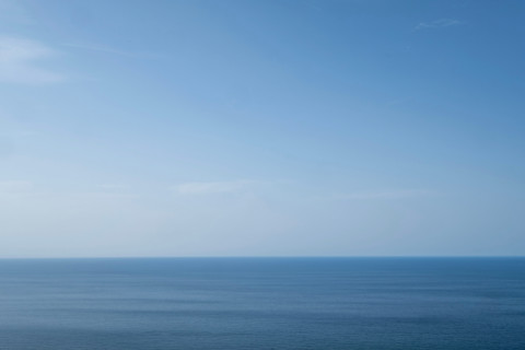 Clear blue sky above calm sea. San Sebastian, Gipuzkoa, Spain