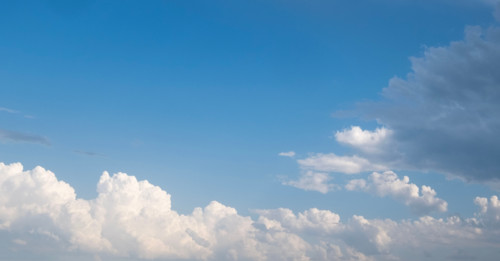 White puffy clouds against blue sky. San Sebastian, Gipuzkoa, Spain