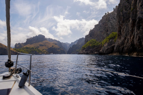 Sailboat on calm sea near cliffs on sunny day. , Mallorca, Spain