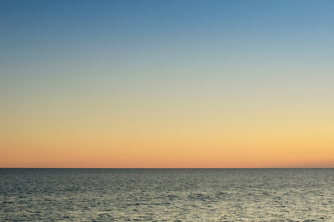 Sunset sky above calm ocean. Cape Cod, Massachusetts, United States
