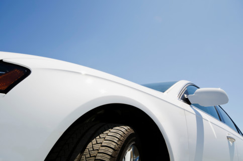 Close-up of white car and blue sky. Mendham, New Jersey, United States