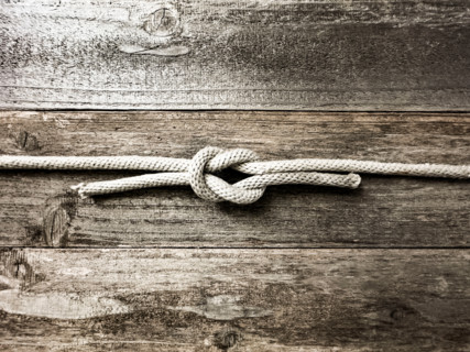 Square knot on wooden surface. Nantucket, Massachusetts, United States