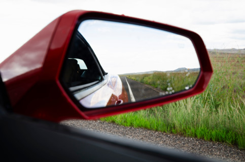 Close-up of side view mirror of car on rural road. , Arizona, United States