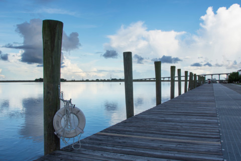 Empty pier on calm Apalachicola River at evening. Apalachicola, Florida, United States