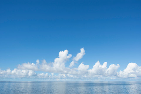 White puffy clouds over calm sea. Eastpoint, Florida, United States
