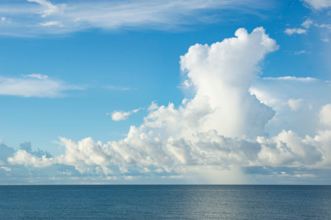 White puffy clouds over calm water. St. George Island, Florida, United States