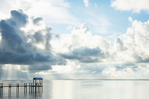 White puffy clouds over calm St. George Sound. Eastpoint, Florida, United States