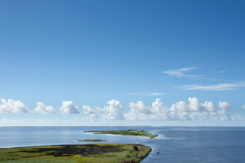 White clouds above calm Apalachicola Bay. Apalachicola, Florida, United States