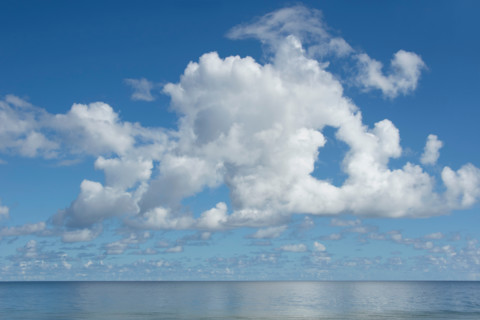 White puffy clouds above calm Apalachicola Bay. Apalachicola, Florida, United States
