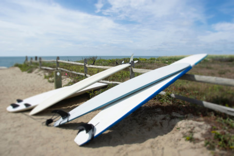Surfboards leaning on fence at Cisco Beach. Nantucket, Massachusetts, United States