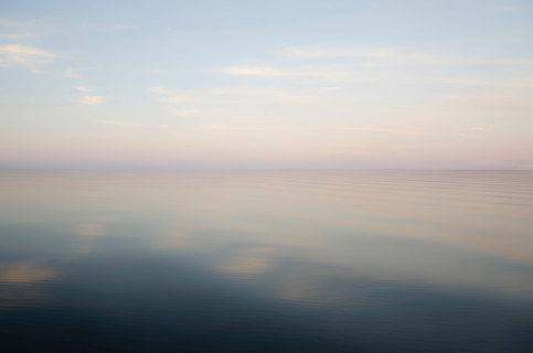 Defocused calm lake surface at sunrise. Pulaski, New York State, United States